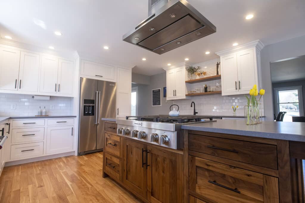 Photo of a half-finished kitchen remodel with exposed wires and incomplete cabinets