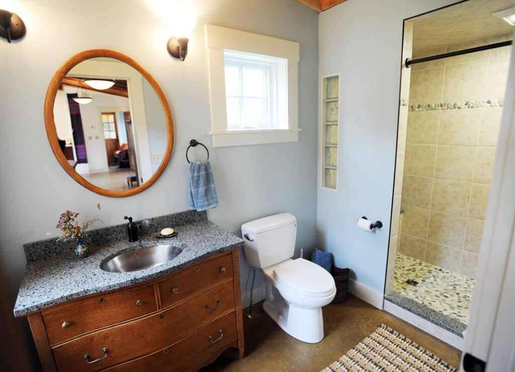 Custom Vermont bathroom remodel featuring natural wood vanity and energy-efficient fixtures